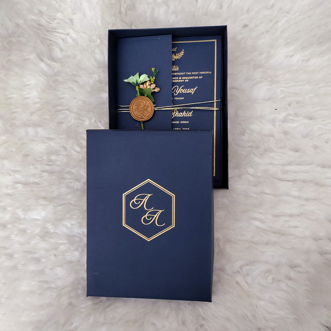 Navy blue Wedding invitation card with gold details on a textured surface