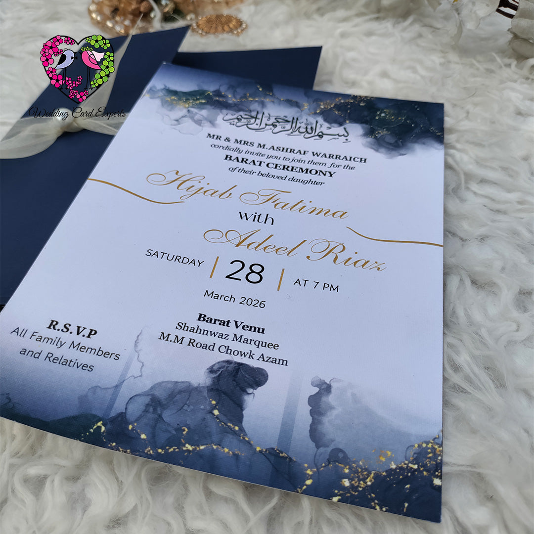 Wedding cards from Pakistan — navy blue pocket folder with organza ribbon beside navy watercolour barat ceremony card with gold script couple names and romantic silhouette, shadi card pakistan