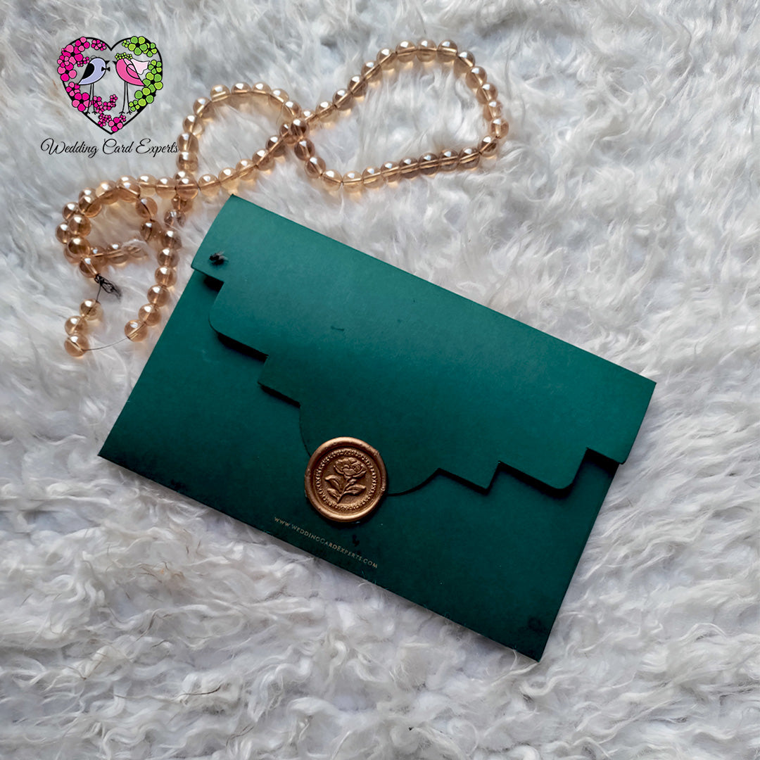 Emerald green scalloped envelope with gold wax seal – custom wedding invitation Pakistan