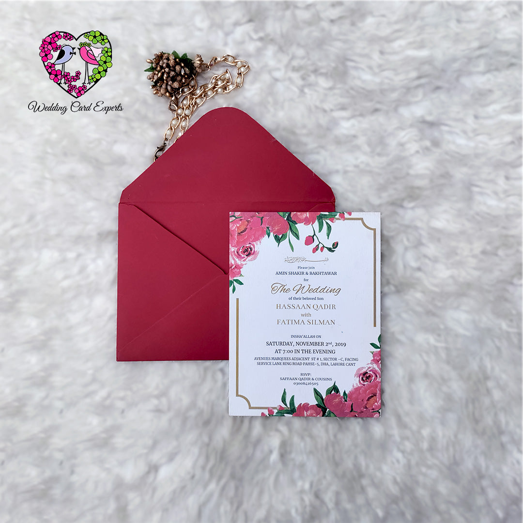 Full pink peony floral wedding card design, top and bottom corner florals, gold border, crimson envelope, Pakistani wedding cards online, Wedding Card Experts

