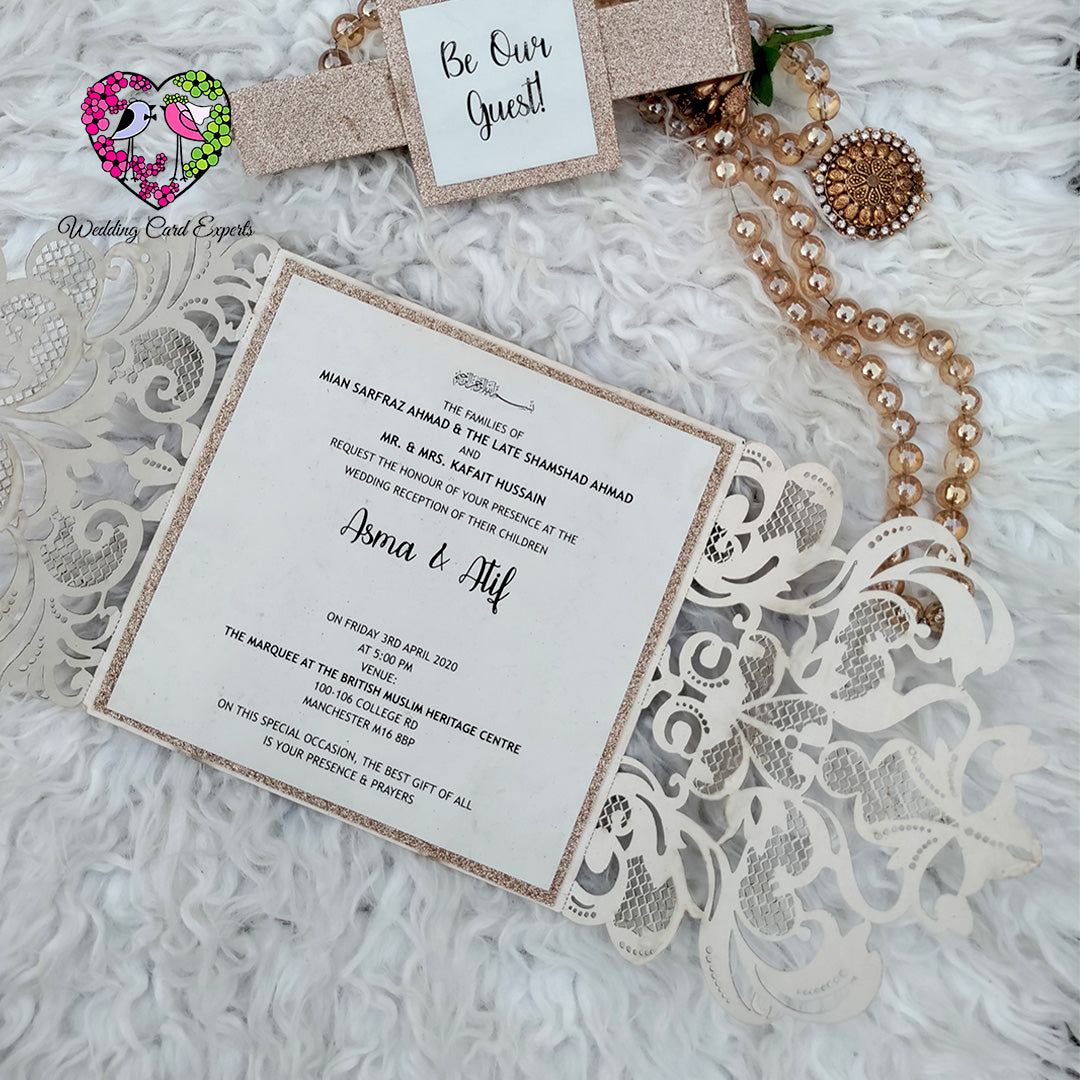 Open glitter gold laser cut gatefold invitation showing ivory insert card wording