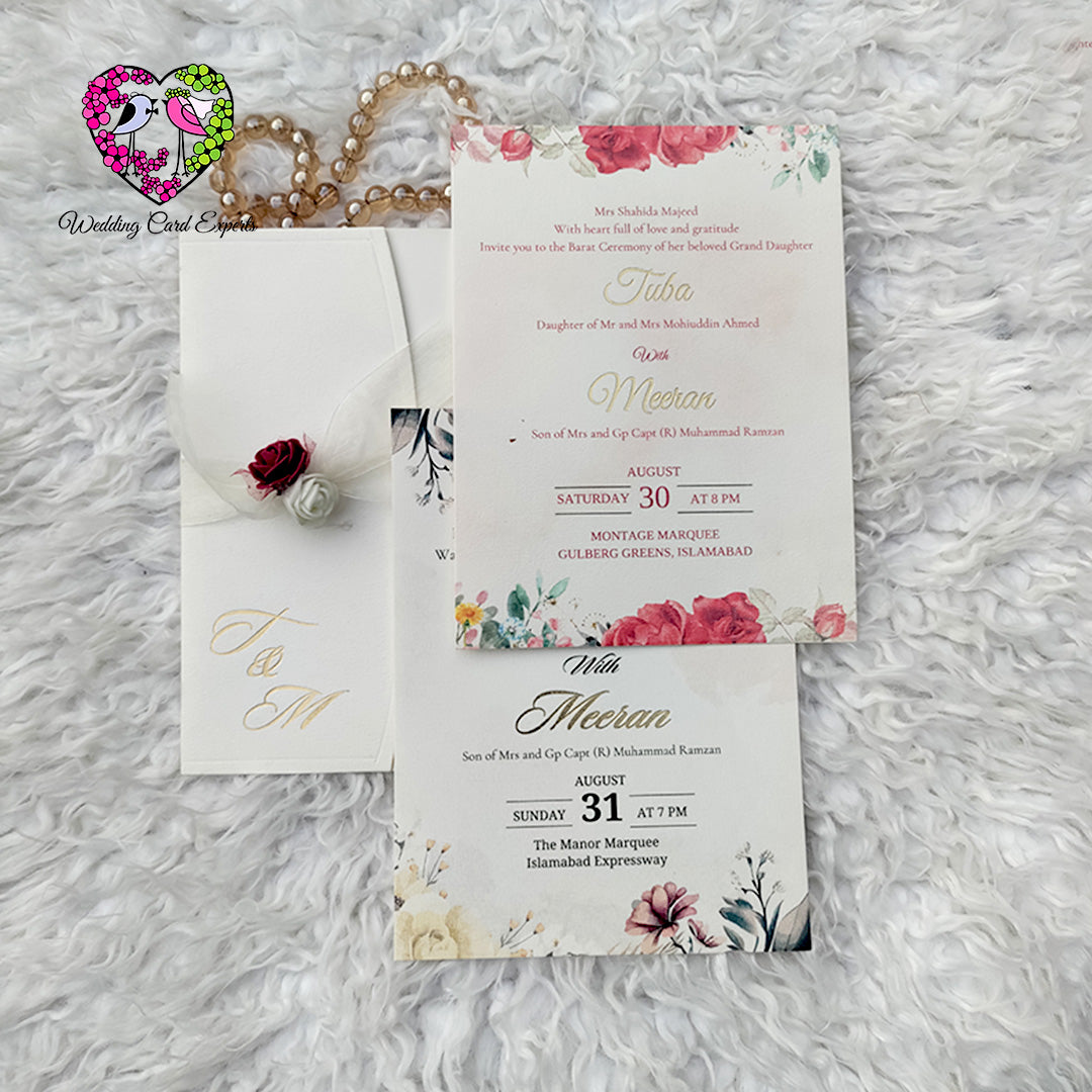 Pakistani Wedding invitation card with floral design on a textured surface