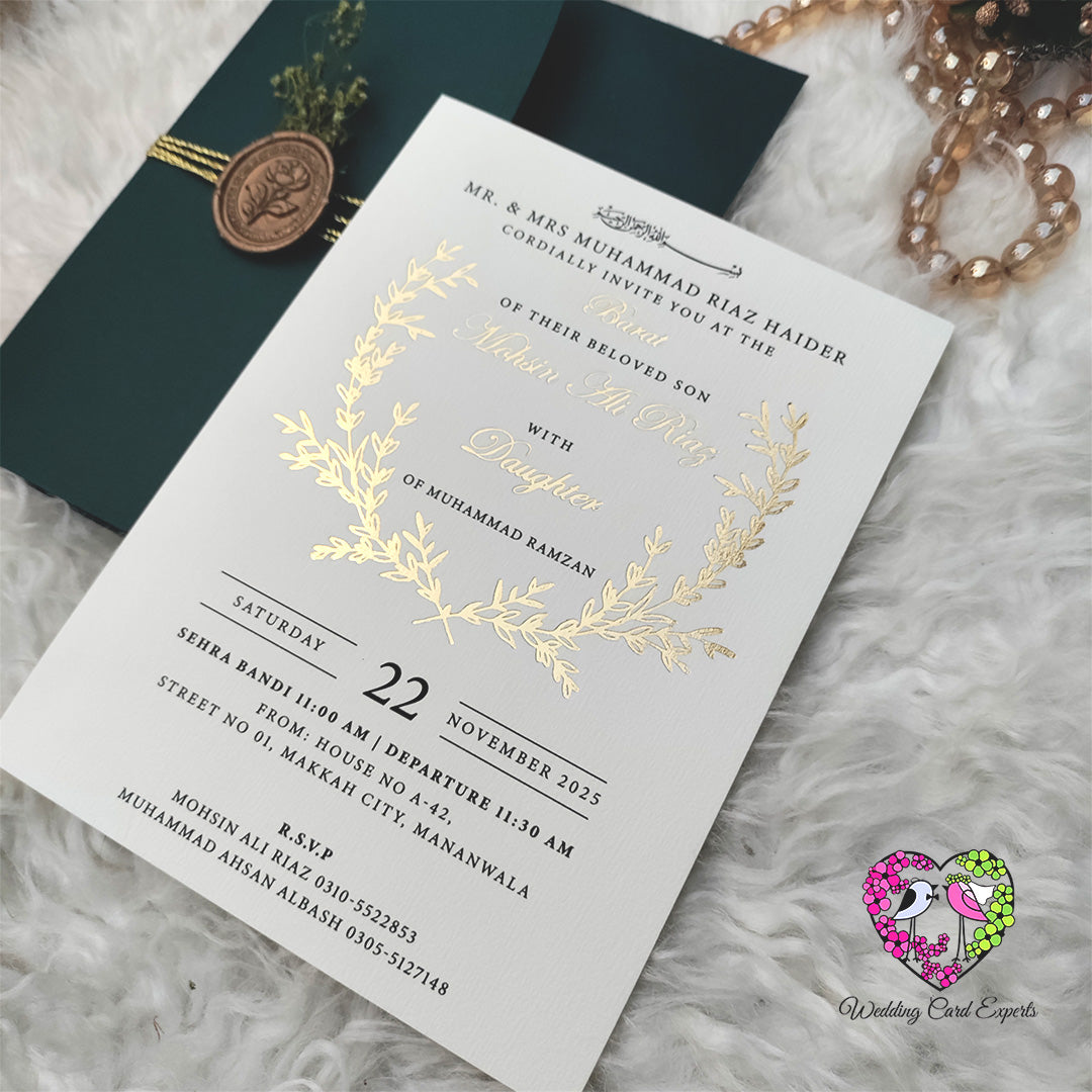 White wedding invitation card, gold foil laurel wreath, elegant calligraphy script, Pakistani Baraat invitation, Wedding Card Experts