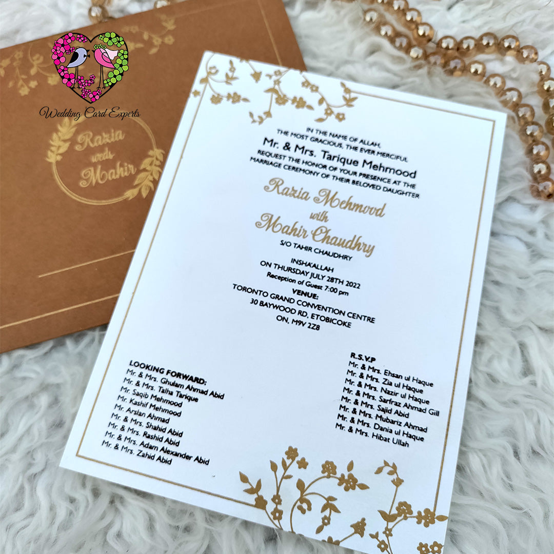 Pakistani wedding card close-up — premium pearl finish white insert card with gold printed botanical border and black gold typography, Pakistani wedding cards shipped to Toronto Canada