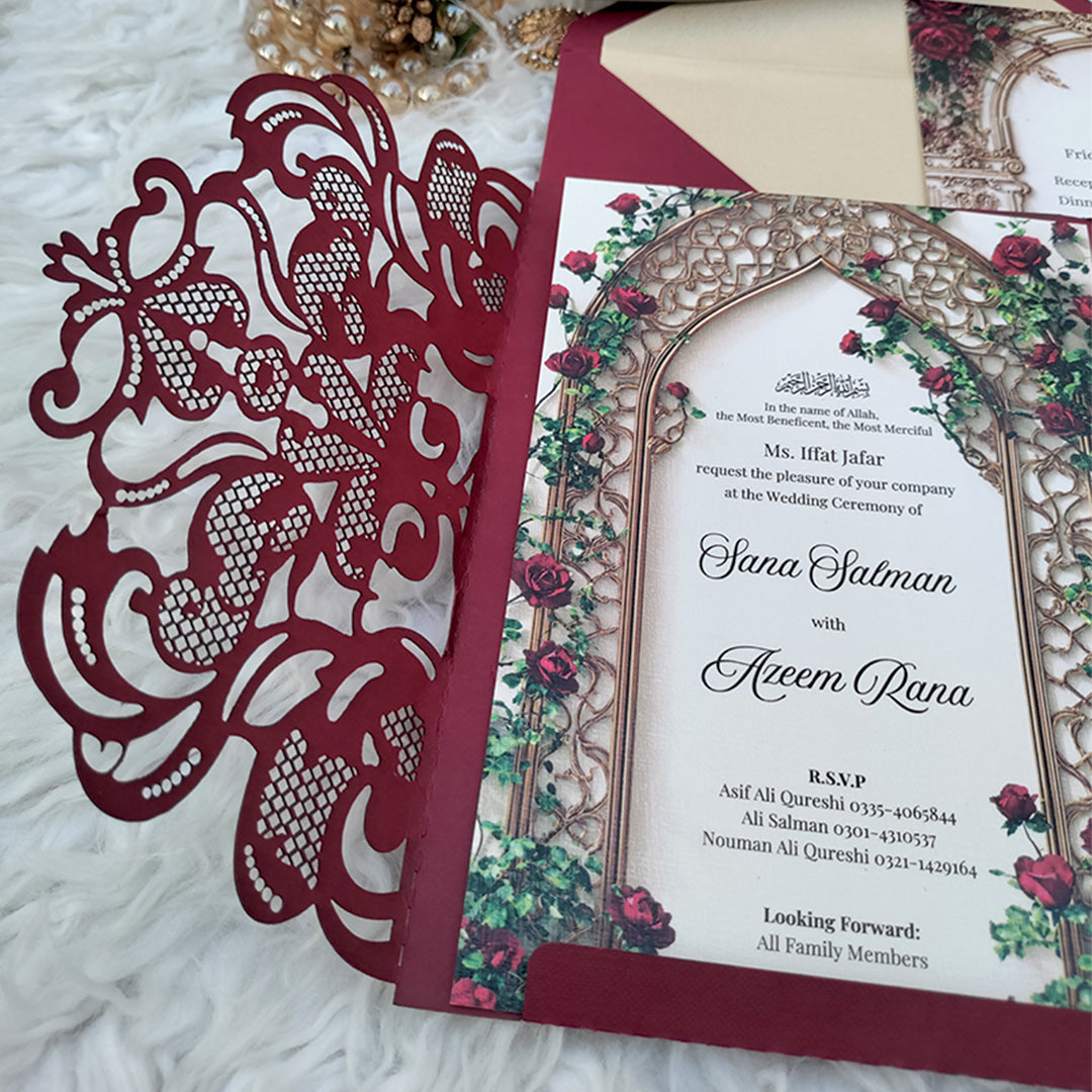 Detail of burgundy laser cut gatefold outer cover showing intricate lace floral pattern with inner card visible