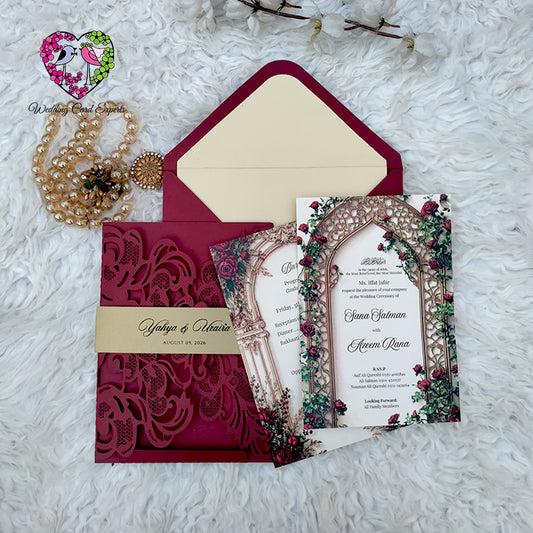 Burgundy laser cut gatefold Pakistani wedding card with floral rose insert, gold belly band and matching envelope — full set